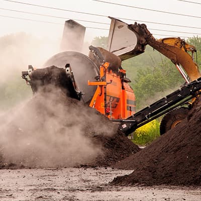 construction excavator moving dirt near nature